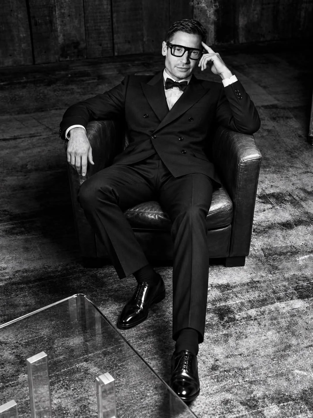 Edward De Valle II, seated in a leather armchair in a black double-breasted dinner jacket